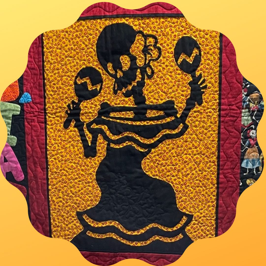 Photo of a quilt with Day of the Dead skeleton.
