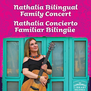 Photo of Nathalia holding an acoustic guitar.