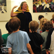 Photo of an SF Opera teacher instructing kids how to sing.