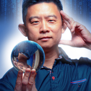 Photo of Dan Chan holding a crystal ball.
