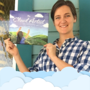 Photo of Merisha Clark holding the book The Cloud Artist
