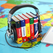 a headset wrapped around books and CDs in different languages