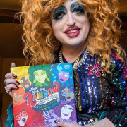 Photo of author Lil Miss Hot Mess holding her book.