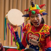 Photo of Chiquy Boom with a colorful tamborine.