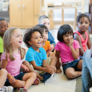 Photo of children sitting and listening to a story.