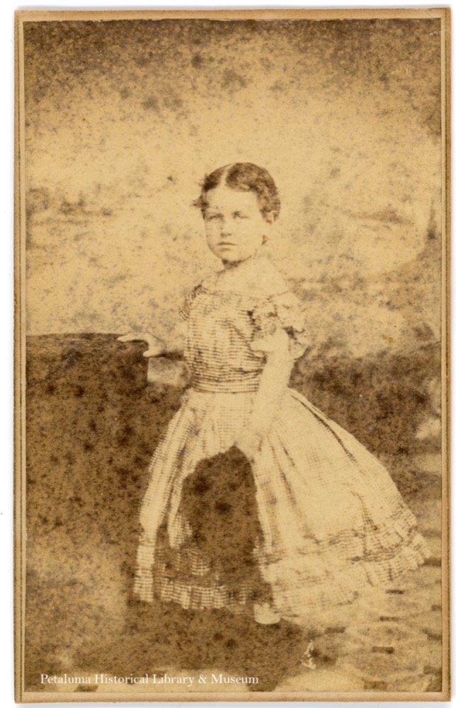 Antique photograph of a small girl wearing a hoop skirt