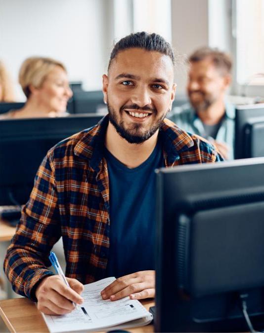 Smiling adult student in computer class.  